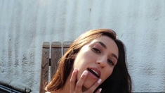 Petite Latina beauty strips in backyard